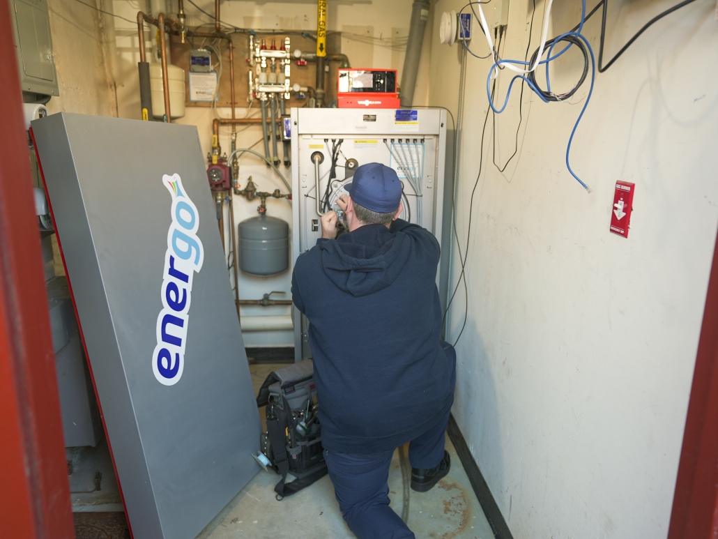 Energo employee working on an indoor HVAC unit