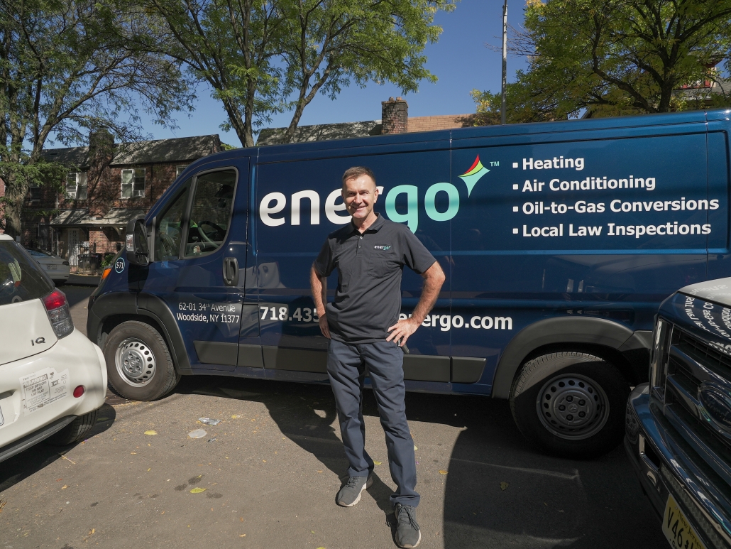 Energo employee standing in front of van with hands on hips