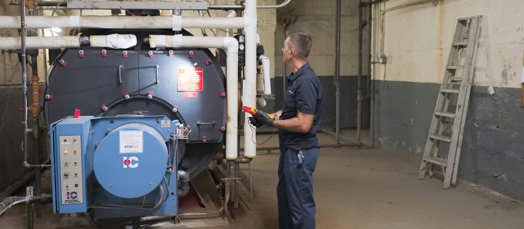 Energo service technician performing boiler safety checks