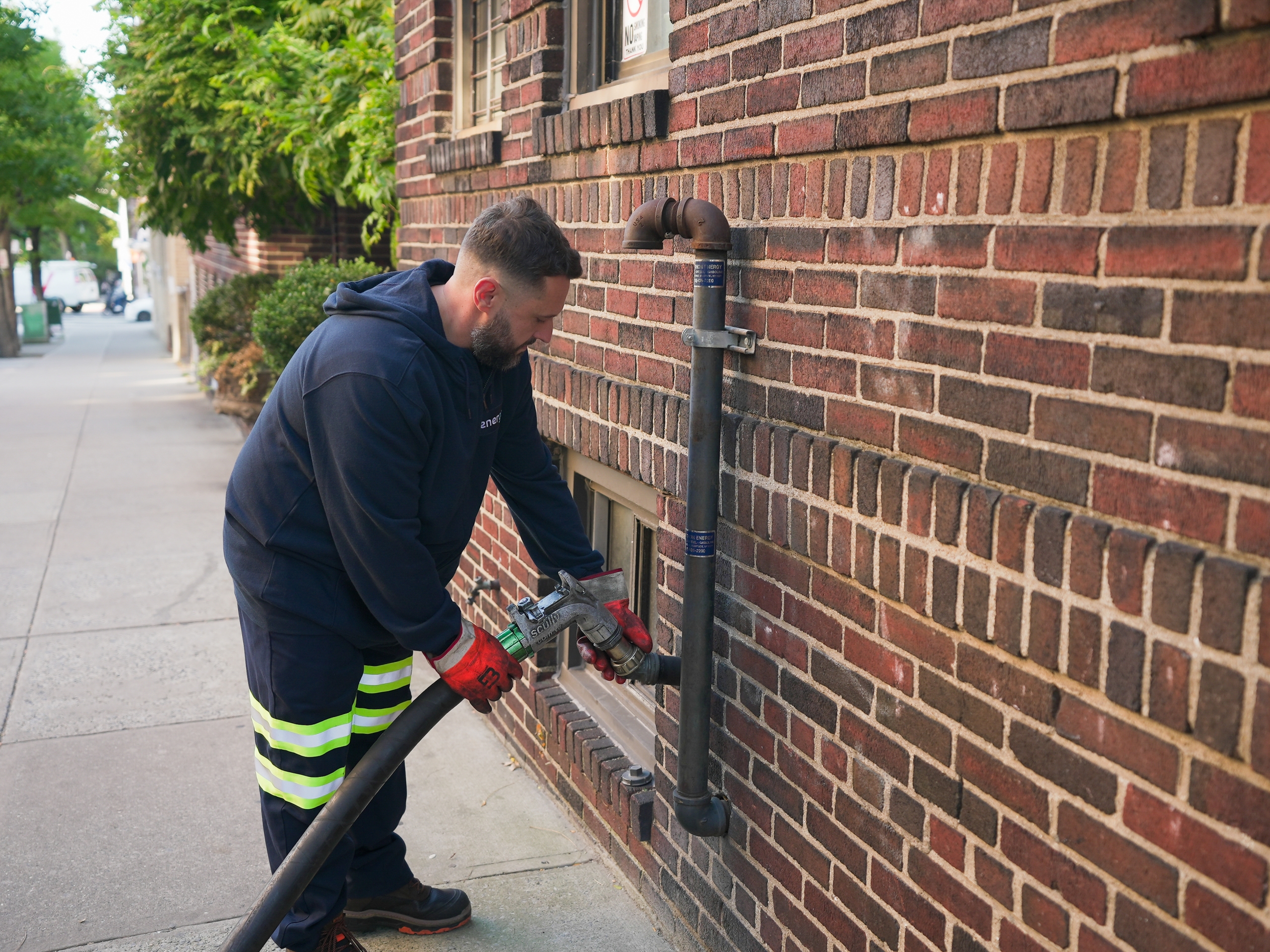Energo technician connecting heating oil delivery line