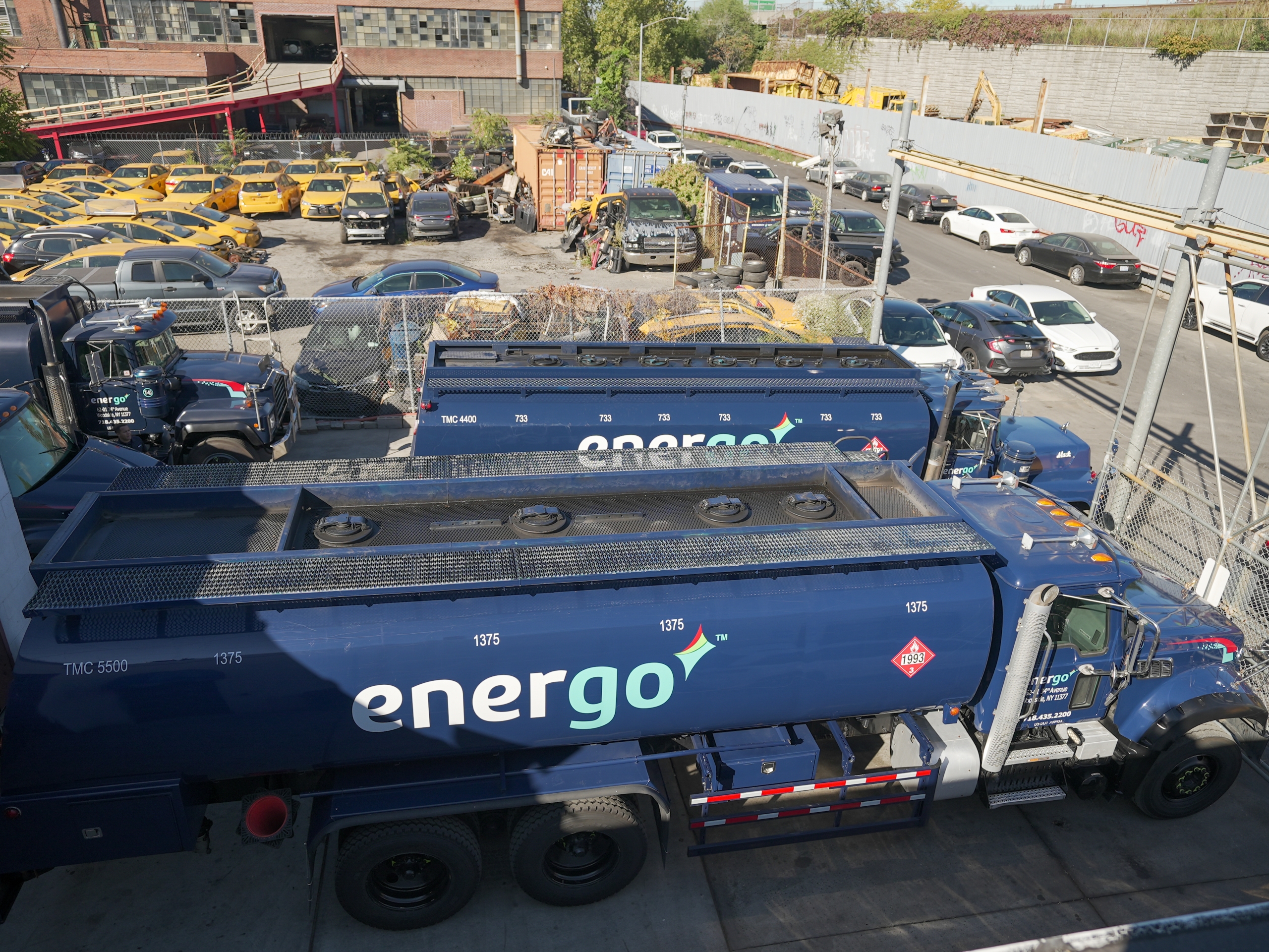 Energo fuel delivery fleet with multiple heating oil trucks in lot