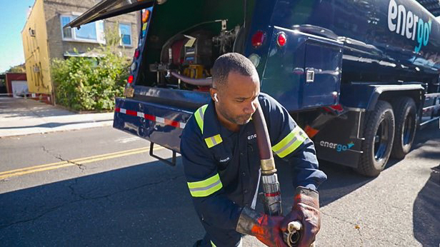 Energo technician connecting heating oil delivery hose in NYC