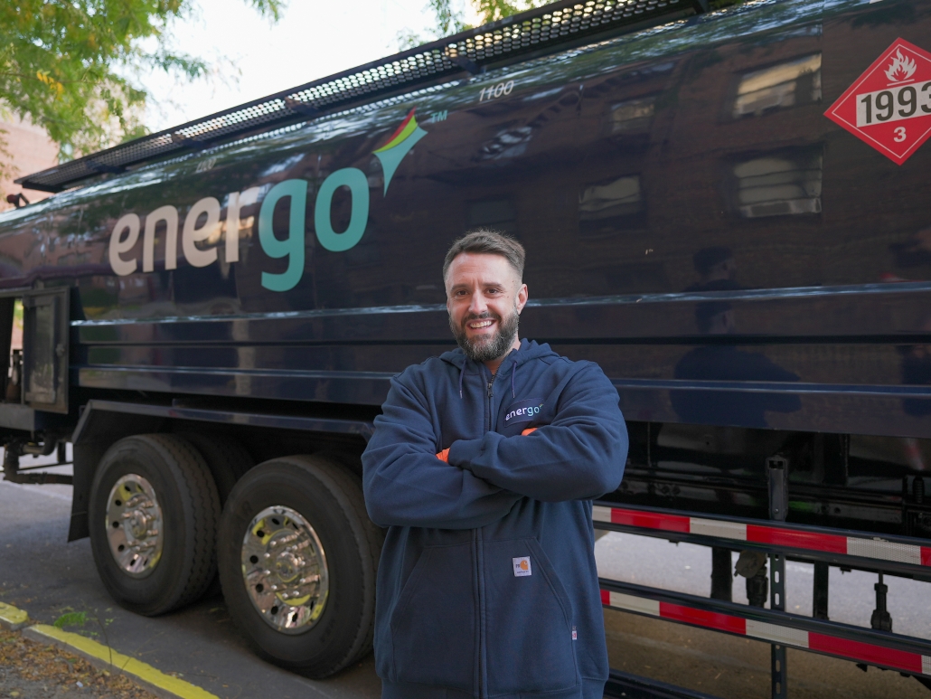 Energo technician posing with heating oil delivery truck in New York