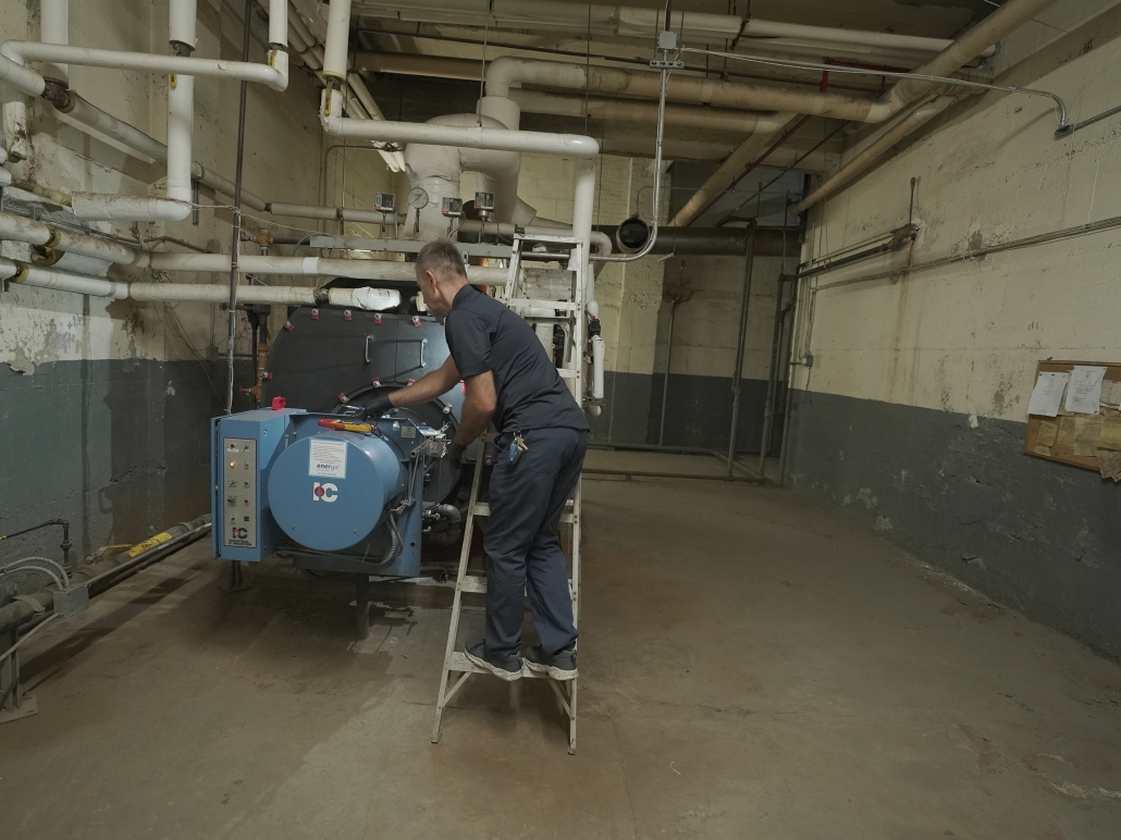 Energo technician repairing commercial boiler system