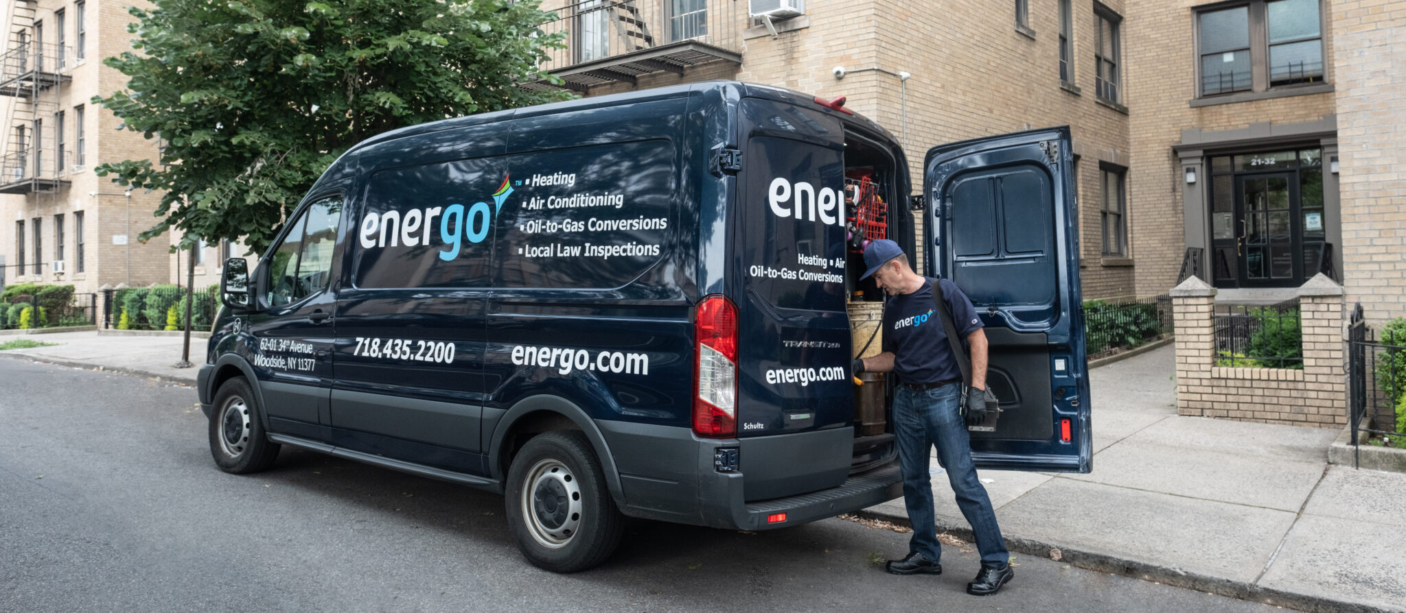 Energo service van parked on NYC street, technician standing nearby