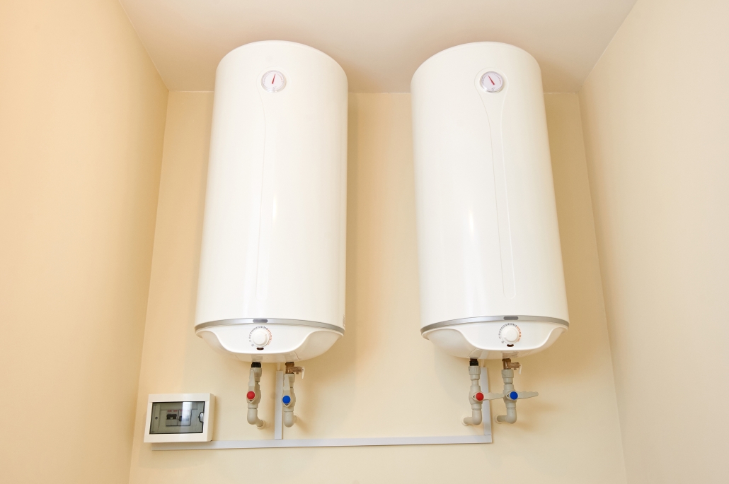 Two electric water heaters on the wall. Home wall mounted two water heating boilers. Two electric water heaters on the wall. Home wall mounted two water heating boilers
