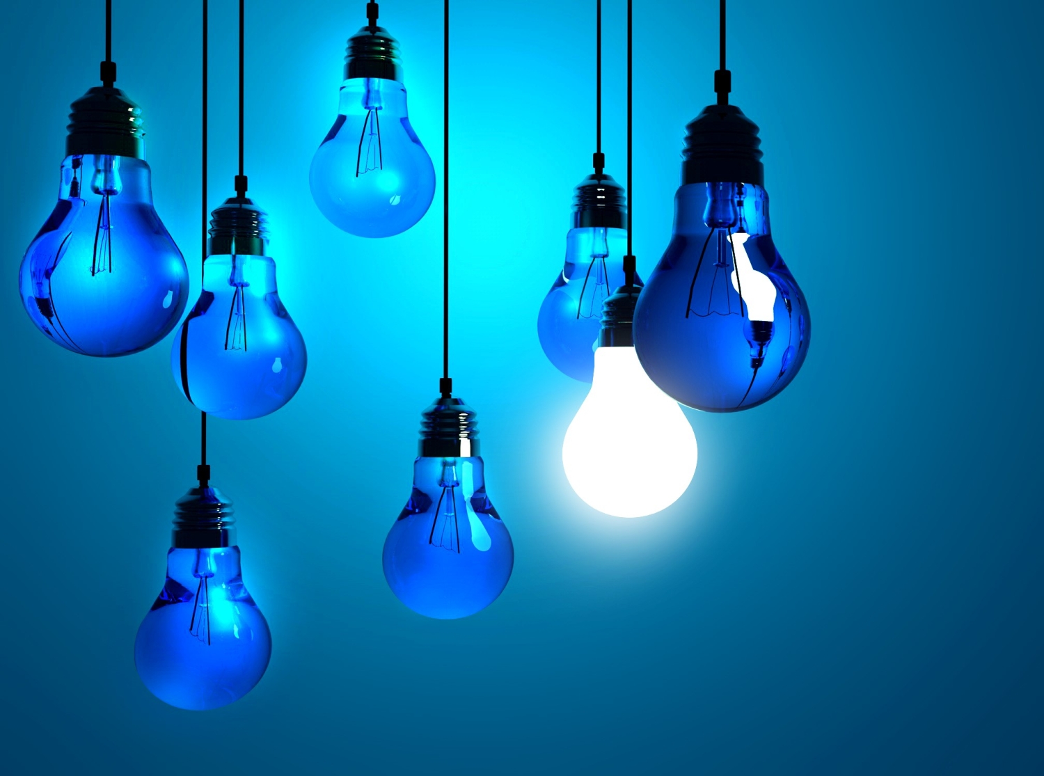 Blue lightbulbs with one glowing bright, symbolizing energy efficiency