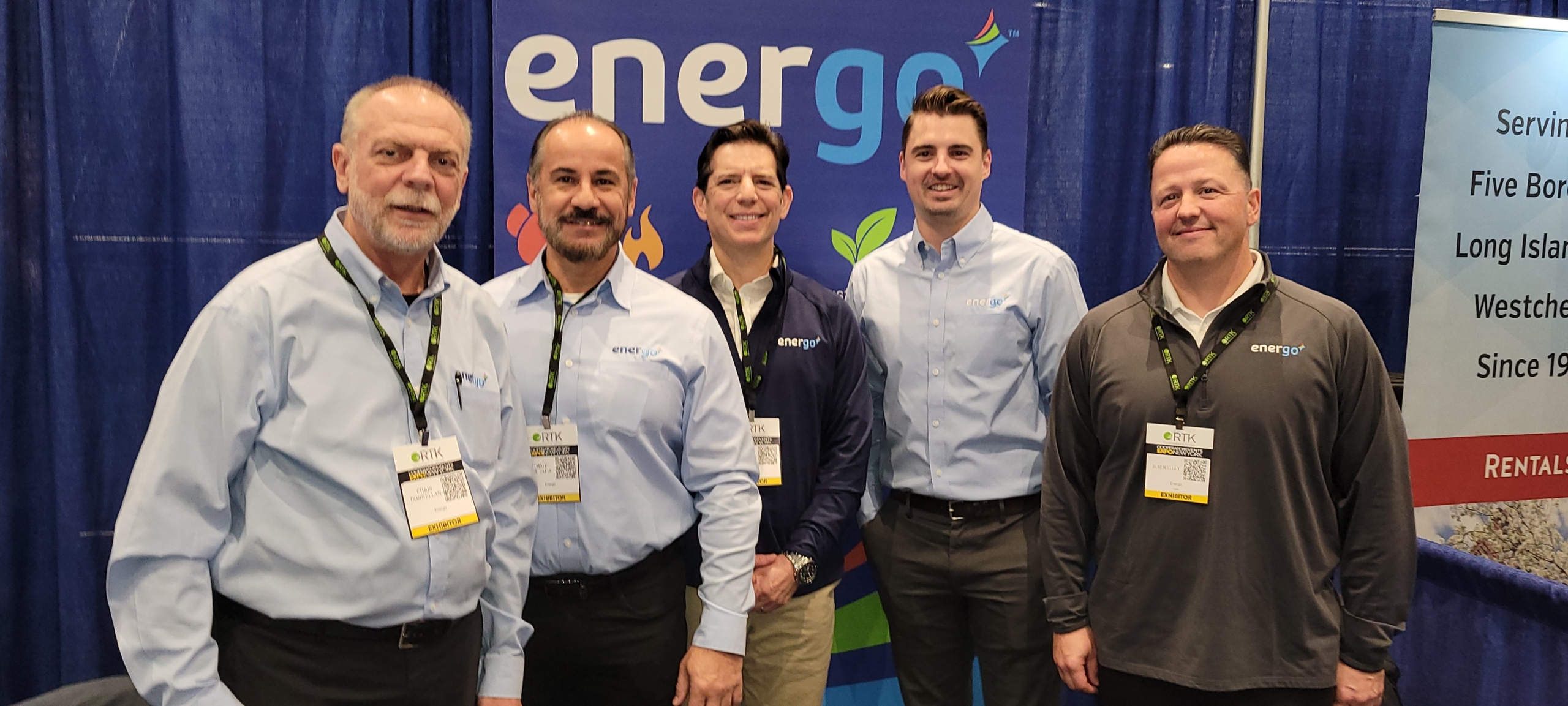 Energo Energy Advisors team at trade show booth with branded backdrop