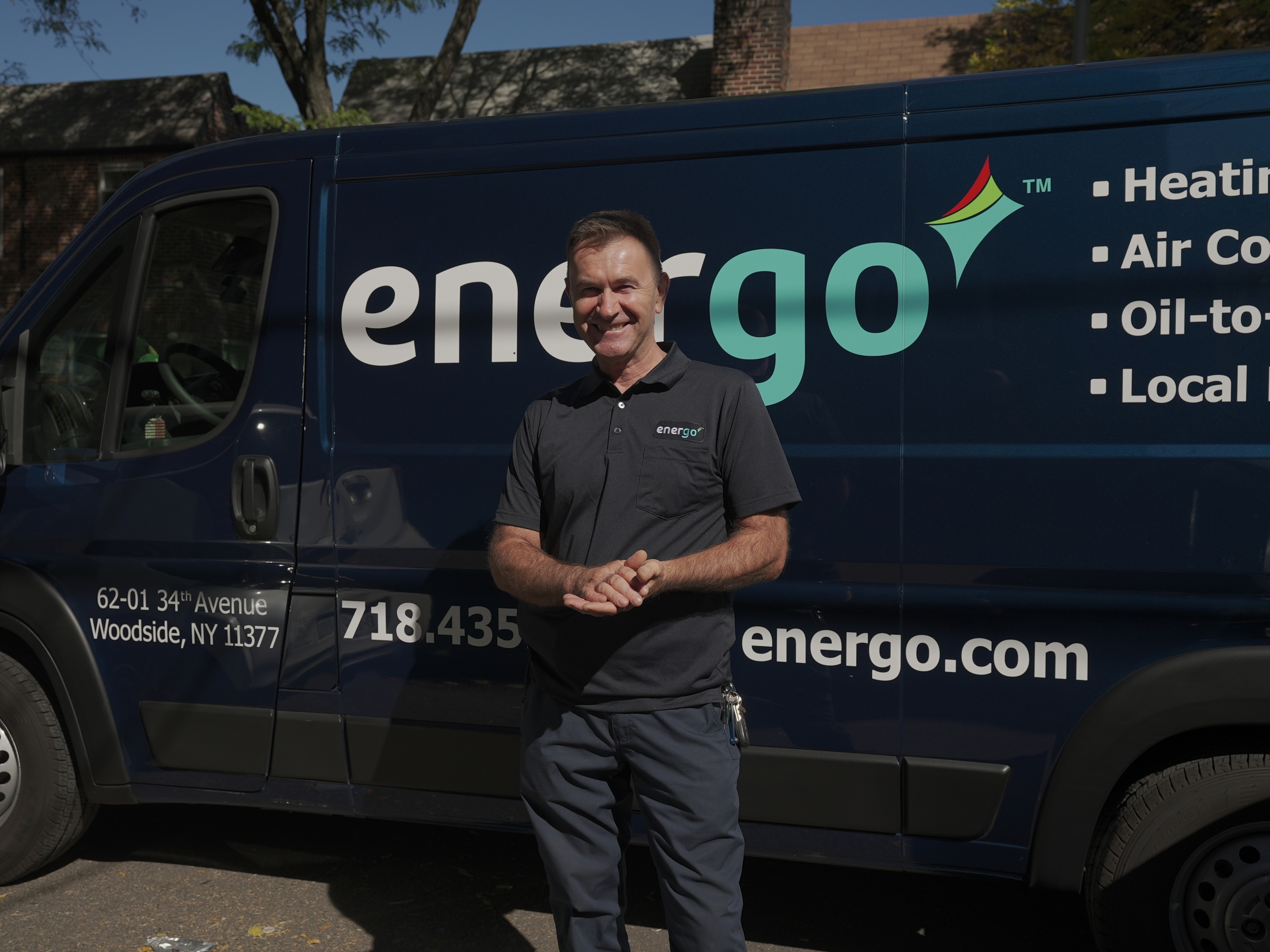 DSC01002 Energo technician standing by branded service van smiling