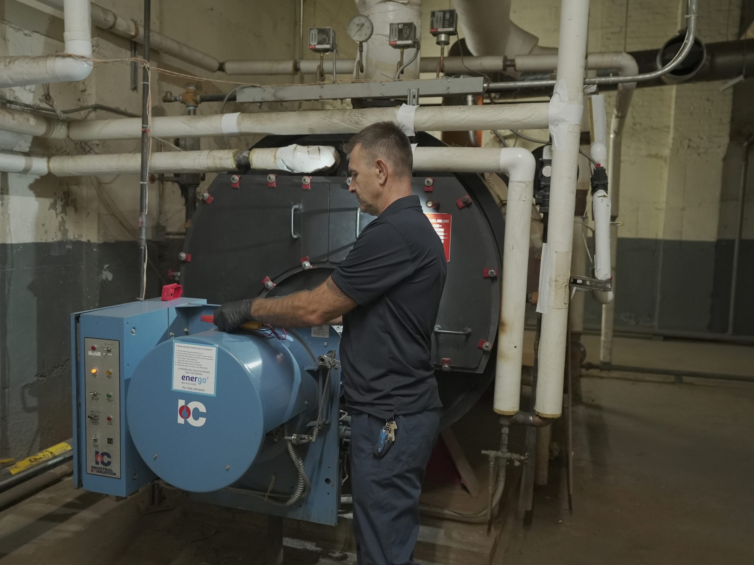 Energo technician performing Local Law 62 boiler inspection in NYC building basement