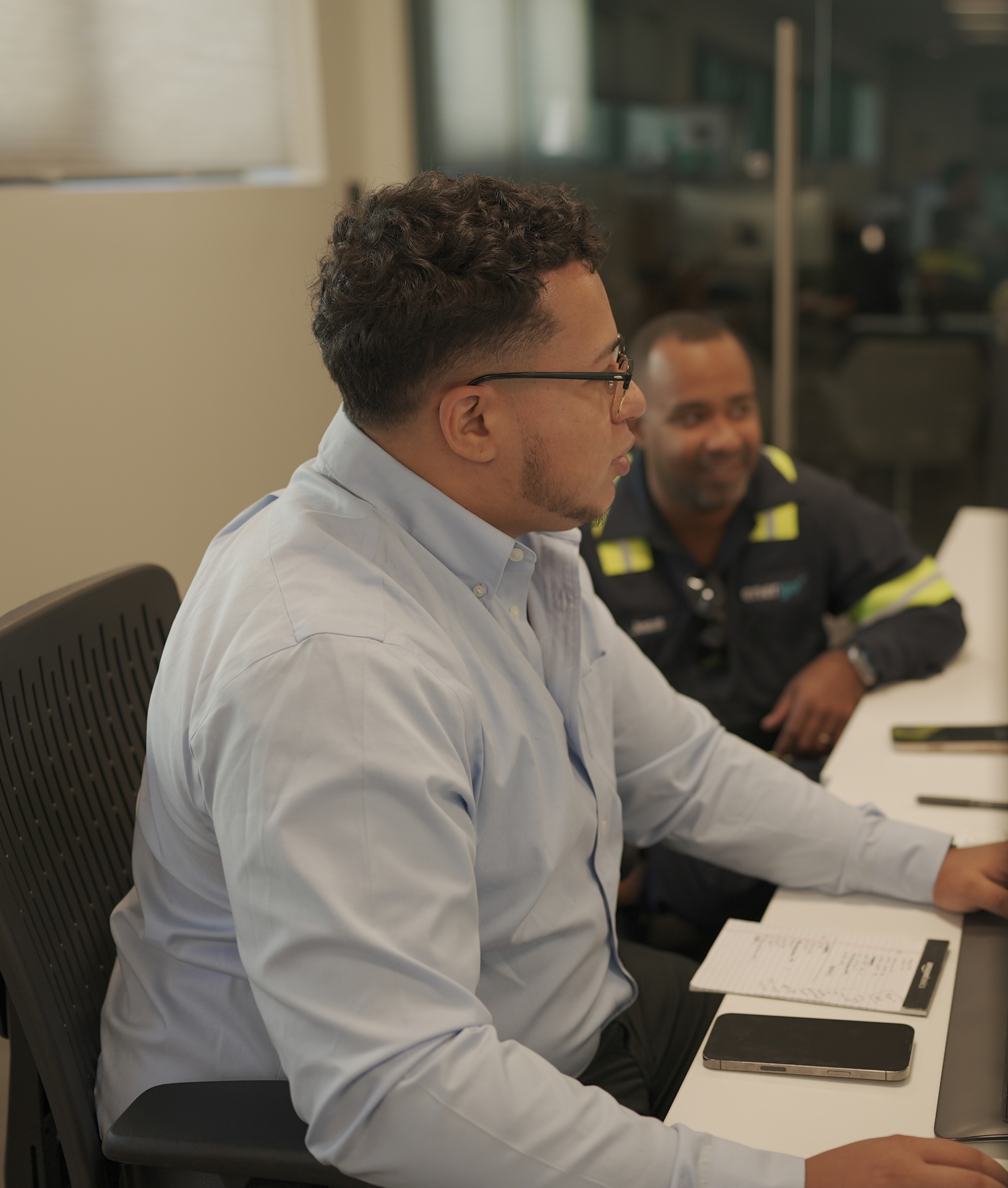 Energo employees collaborating at computer workstation in office