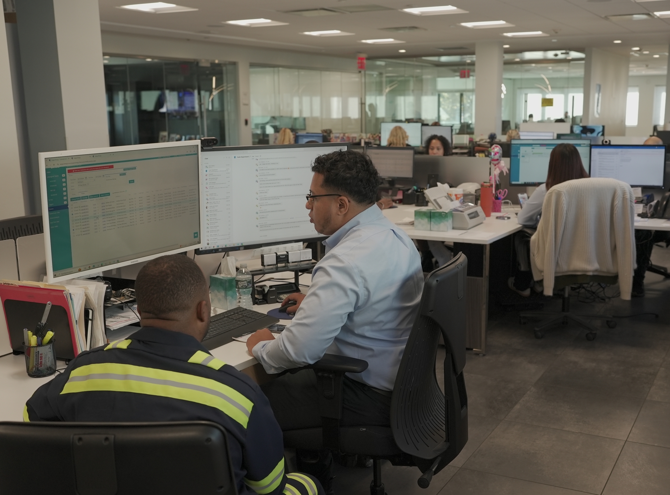 Energo office team working at multiple computer stations in open workspace