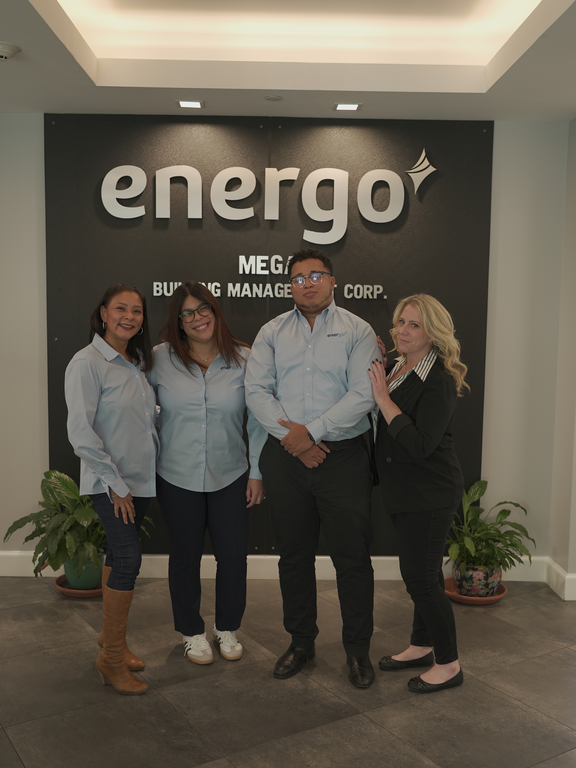 Energo team standing together in company office lobby