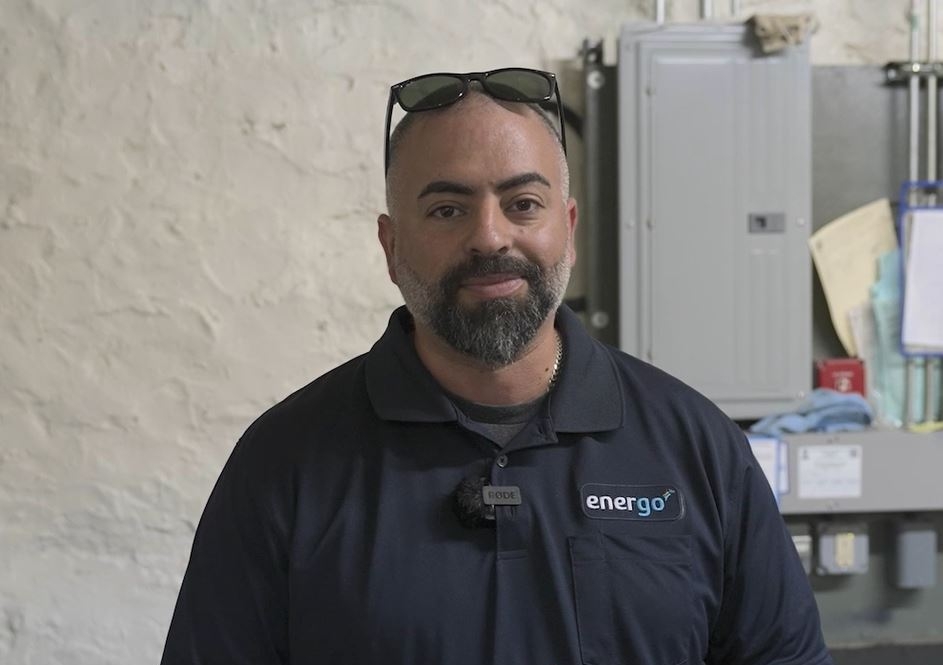 Energo staff member in branded polo shirt speaking to camera