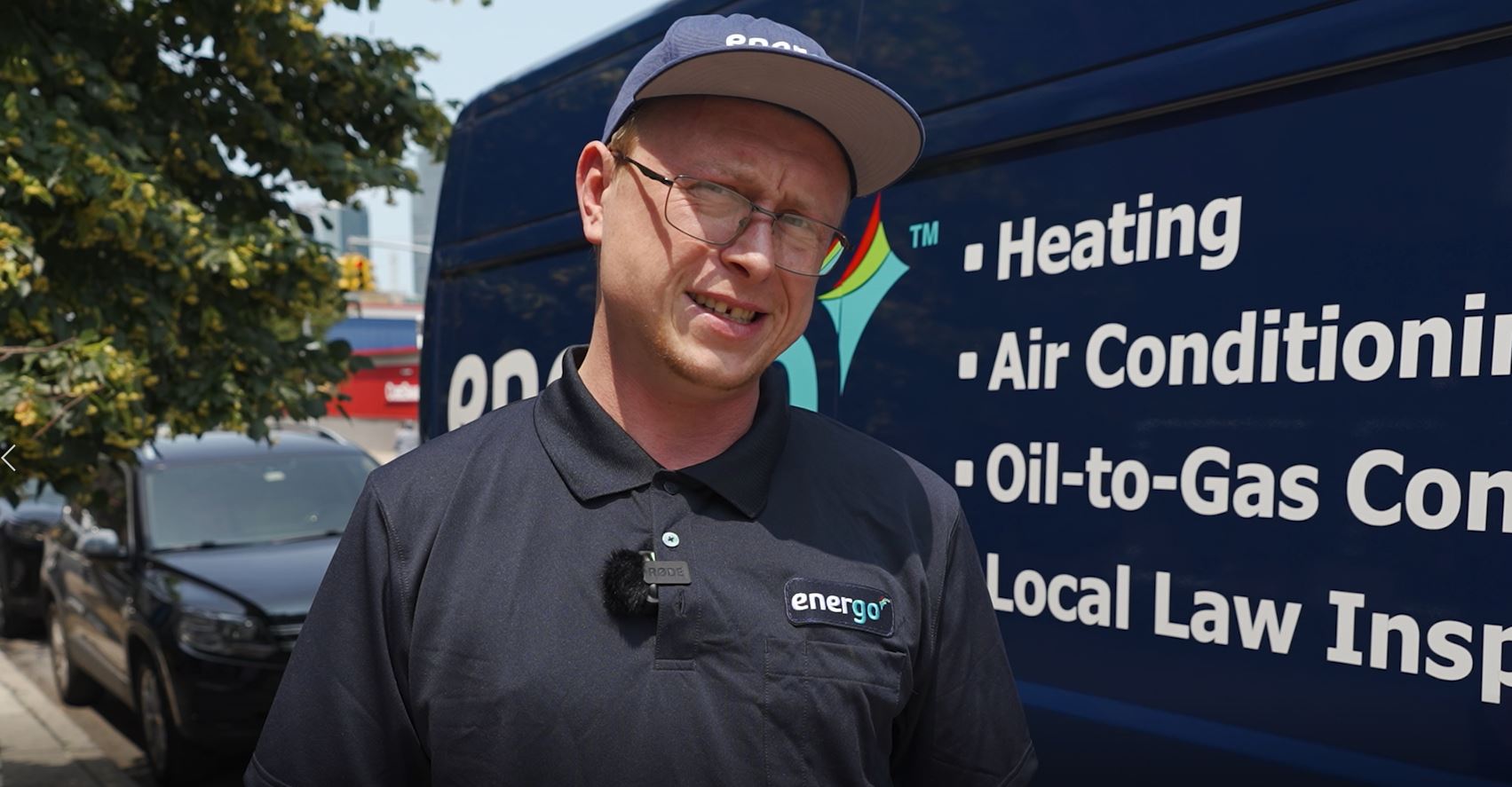 Energo technician in uniform giving interview outdoors