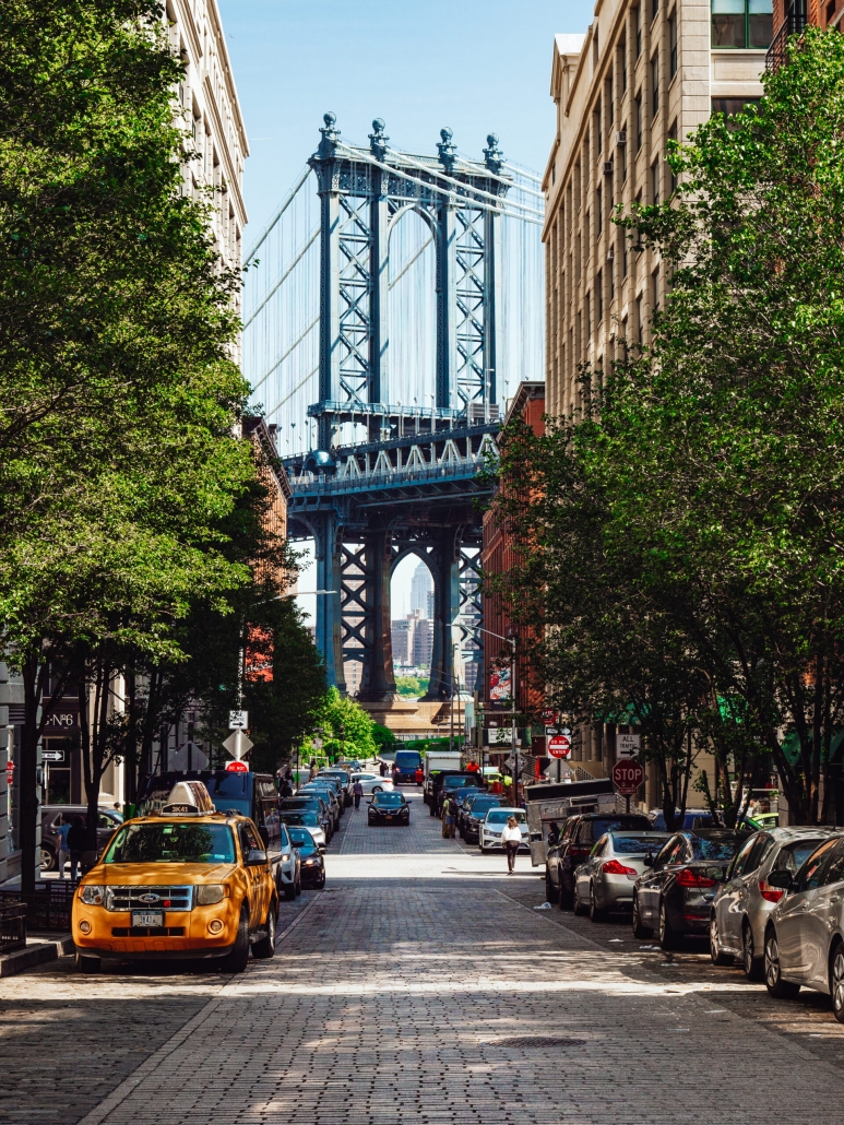 Brooklyn street view with Brooklyn bridge and yellow taxi