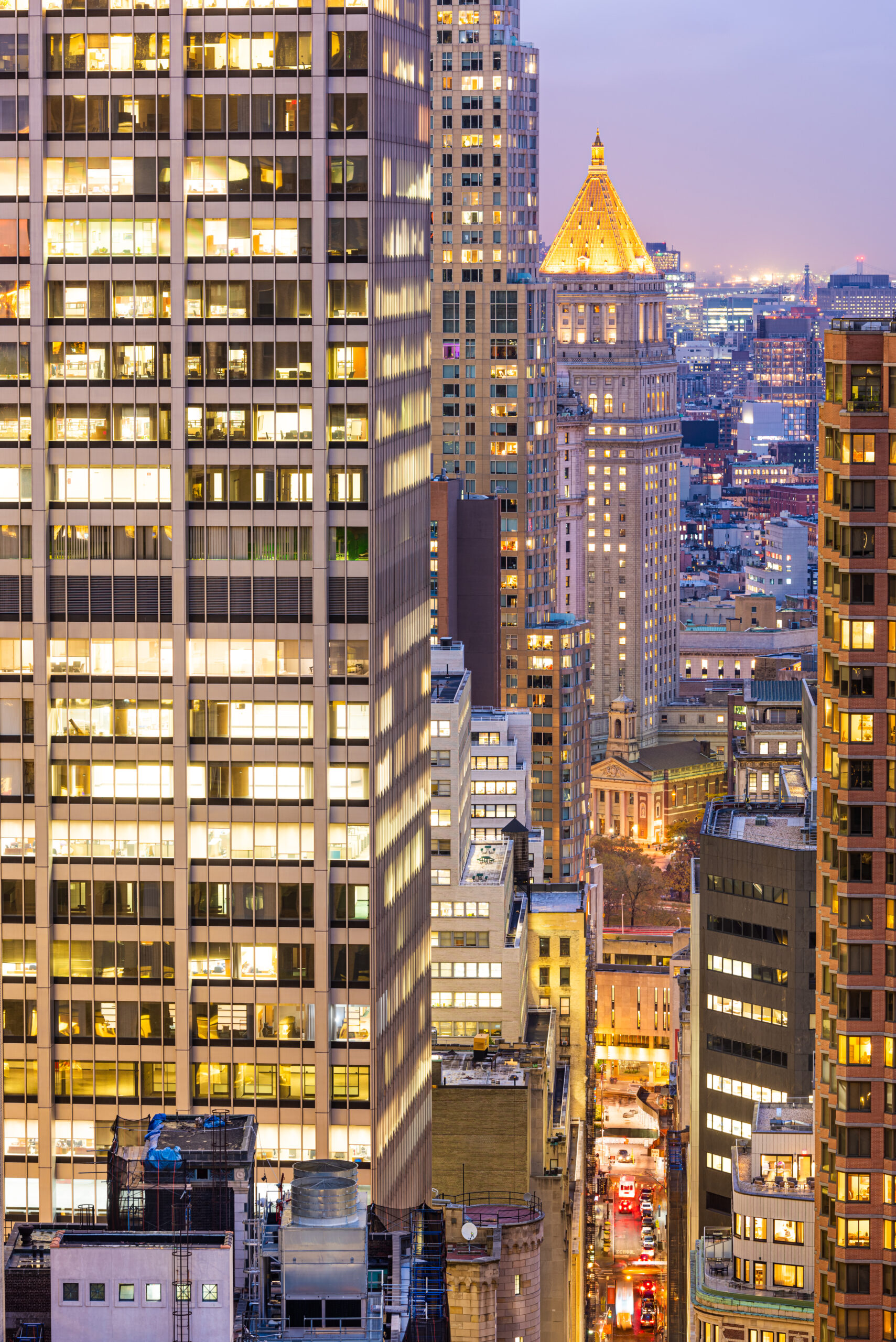 NYC office building exterior lit up at night