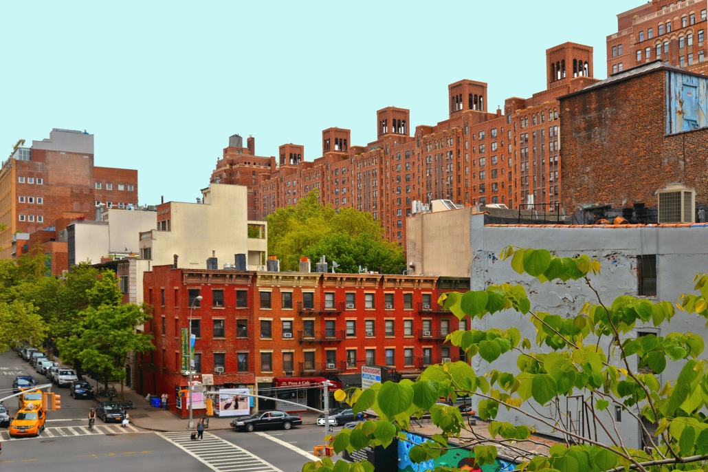buildings, modern and old architecture, busy traffic and people on the streets in downtown manhattan near high line in new york Red brick apartment buildings in Manhattan neighborhood