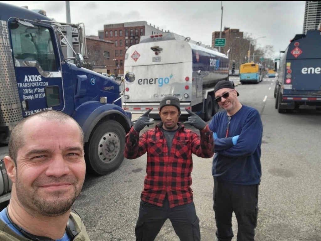 Group of Energo technicians posing for photo in front of fuel delivery truck